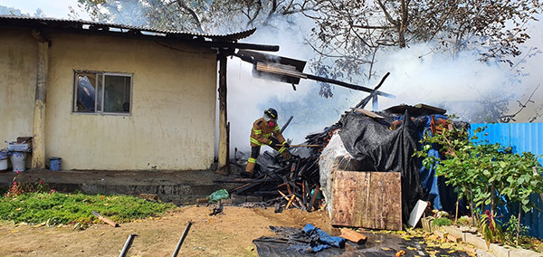 마로면 갈전리 주택 아궁이에서 번진 화재를 소방관이 진압하고 있다.