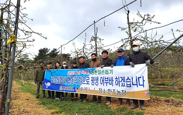 농가일손돕기의 일환으로 사과꽃따기 작업을 펼친 보은신협 직원들이 풍년을 기원하고 있다.