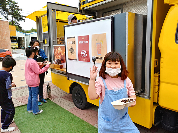 탄부초 학생들이 맛있는 음식을 받아가며 좋아라 하고 있다.