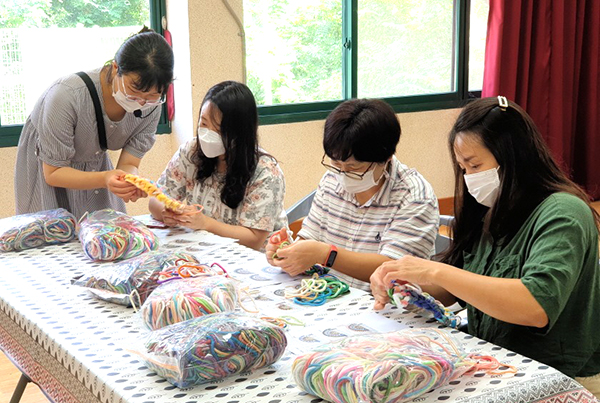 수한초 학부모들이 버려진 양말목으로 발매트를 만들며 환경보호 의지를 키우고 있다.