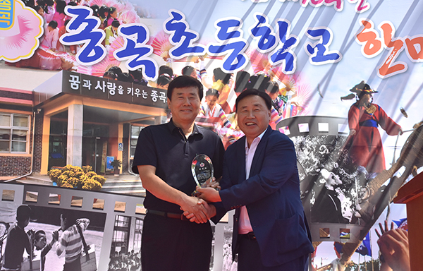 종곡초총동문회 김홍락 회장이 동문회 발전에 기여한 강현국 동문에게 공로패를 수여하고 있다.