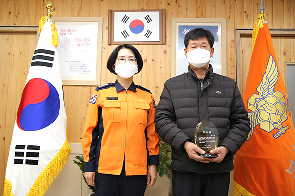 김혜숙 보은소방서장이 김홍철씨에게 감사패를 전달하고 있다.