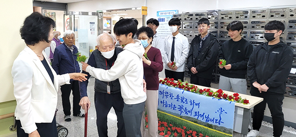 보은군실버복지관을 찾은 보은중학생들이 어르신들께 카네이션을 달아 드리고 있다.