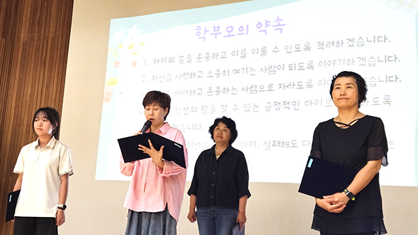 아웃도어 캠핑 체험에 참여한 학부모가 생활 협약을 발표하고 있다.