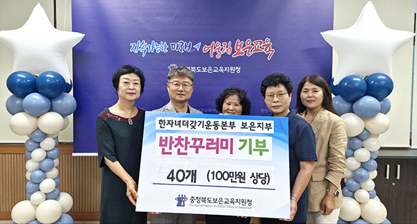 한자녀더갖기운동보은지부가 ‘사랑의 반찬꾸러미’를 전병일 교육장에게 전달하고 있다.