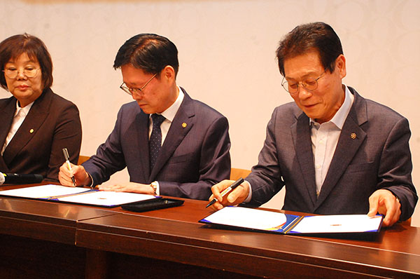 정경재 보은문원원장과 전용한 광진문원장이 자매결연 협약서에 서명하고 있다.